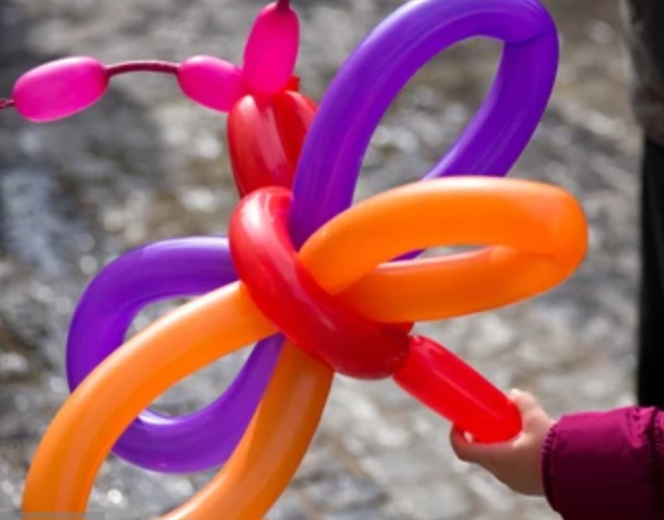 Colorful balloon animal flower twisted from red, purple, orange and pink balloons